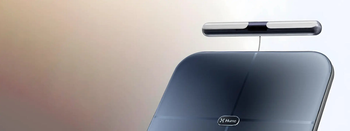 Close-up of Hume Body Pod scale with detachable handlebar sensor, showcasing sleek design for advanced body composition measurement.